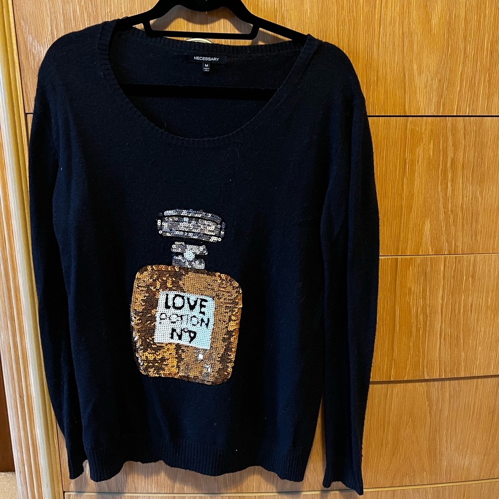 Black sweater with sequin love potion no 9 bottle